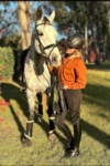 burnt chestnut hoodie front next to horse performa ride